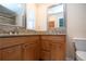 Bathroom featuring granite countertops, wood cabinets, and dual sinks at 5621 Palm Aire Dr, Sarasota, FL 34243