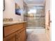 Bathroom with a tiled shower, granite countertops, and wood cabinets at 5621 Palm Aire Dr, Sarasota, FL 34243
