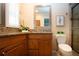 Bathroom with a vanity featuring a stone countertop, modern mirror, and glass-enclosed shower stall at 5621 Palm Aire Dr, Sarasota, FL 34243
