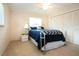 Cozy bedroom with a ceiling fan, window with blinds, and large closet at 5621 Palm Aire Dr, Sarasota, FL 34243