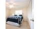 Cozy bedroom with a ceiling fan, window with blinds, and large closet at 5621 Palm Aire Dr, Sarasota, FL 34243