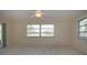 Spacious bedroom with a large window, a sliding glass door to the outside, and a ceiling fan at 5621 Palm Aire Dr, Sarasota, FL 34243