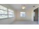 Bright bedroom with a ceiling fan, windows and view to the outdoors, plus an ensuite bathroom at 5621 Palm Aire Dr, Sarasota, FL 34243