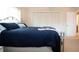 Comfortable bedroom with a ceiling fan, window with blinds, and closet space at 5621 Palm Aire Dr, Sarasota, FL 34243