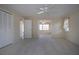 Bedroom featuring closet doors, bathroom access, neutral walls, and natural light, creating a comfortable and inviting space at 5621 Palm Aire Dr, Sarasota, FL 34243