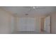 Bedroom featuring a ceiling fan, double closets, neutral walls and carpeting, plus a doorway to the ensuite bathroom at 5621 Palm Aire Dr, Sarasota, FL 34243