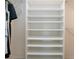 Walk-in closet featuring a wall of shelves, a hanging rod for clothing, and neutral colored walls at 5621 Palm Aire Dr, Sarasota, FL 34243