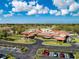 Aerial view of the clubhouse featuring a well-manicured landscape and convenient parking at 5621 Palm Aire Dr, Sarasota, FL 34243