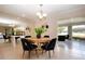 Open dining area with wood table, black chairs, and backyard view from the sunroom at 5621 Palm Aire Dr, Sarasota, FL 34243