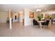 Open dining area adjacent to kitchen with stylish black velvet chairs and mirrored wall at 5621 Palm Aire Dr, Sarasota, FL 34243