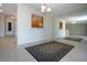 Spacious dining room with tiled floors, an accent mirror, and view to the kitchen area at 5621 Palm Aire Dr, Sarasota, FL 34243