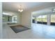 Dining room features tile flooring, a large mirrored wall, and scenic view through sliding glass doors at 5621 Palm Aire Dr, Sarasota, FL 34243
