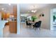 Cozy dining area features wood table and black chairs, connecting to a modern kitchen at 5621 Palm Aire Dr, Sarasota, FL 34243