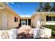 Charming entrance featuring a dark front door, brick walkway, and manicured landscaping at 5621 Palm Aire Dr, Sarasota, FL 34243
