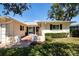 Inviting entrance with a brick walkway leading to a white front door and manicured bushes at 5621 Palm Aire Dr, Sarasota, FL 34243