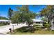Single story home with well-maintained lawn, two-car garage, shade tree, and nice landscaping at 5621 Palm Aire Dr, Sarasota, FL 34243