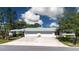 Charming home with a two-car garage, beautiful landscaping, and a spacious driveway at 5621 Palm Aire Dr, Sarasota, FL 34243