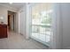 View of the foyer with a large window, tile flooring, and white trim at 5621 Palm Aire Dr, Sarasota, FL 34243