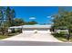 Charming single story home with a well manicured lawn, two-car garage, and beautiful landscaping at 5621 Palm Aire Dr, Sarasota, FL 34243