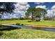 Picturesque view of a golf course with lush green fairways and mature trees, offering scenic recreational opportunities at 5621 Palm Aire Dr, Sarasota, FL 34243