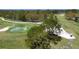 Aerial view of the beautiful lush green golf course featuring mature trees and a water feature at 5621 Palm Aire Dr, Sarasota, FL 34243