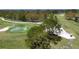 Scenic view of the golf course with a water hazard and pristine green grass at 5621 Palm Aire Dr, Sarasota, FL 34243