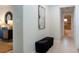 Bright hallway featuring tiled flooring, decorative wall art, and convenient access to other areas of the home at 5621 Palm Aire Dr, Sarasota, FL 34243