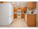 Bright kitchen features white appliances and wooden cabinets at 5621 Palm Aire Dr, Sarasota, FL 34243
