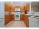 Kitchen features wooden cabinets and modern appliances at 5621 Palm Aire Dr, Sarasota, FL 34243