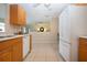 Bright kitchen featuring stainless steel appliances, tile flooring, and an open view to a dining or living area at 5621 Palm Aire Dr, Sarasota, FL 34243
