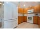 Kitchen with a white refrigerator and range oven at 5621 Palm Aire Dr, Sarasota, FL 34243
