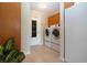 The laundry room features a side-by-side washer and dryer, cabinets, and a door to the outside at 5621 Palm Aire Dr, Sarasota, FL 34243