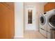 Laundry room features cabinetry and appliances at 5621 Palm Aire Dr, Sarasota, FL 34243