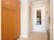 Laundry room with wooden storage cabinets and door to garage at 5621 Palm Aire Dr, Sarasota, FL 34243