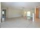 Spacious living room with neutral walls, tiled floor, and natural light at 5621 Palm Aire Dr, Sarasota, FL 34243