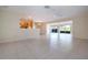 Bright and airy living room with tiled floors and a view of the golf course through large sliding glass doors at 5621 Palm Aire Dr, Sarasota, FL 34243
