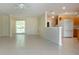 Spacious living room featuring a bright kitchen and tile floors at 5621 Palm Aire Dr, Sarasota, FL 34243