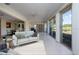 Comfortable living room with tile floors and views of the golf course, complete with a couch and dining area at 5621 Palm Aire Dr, Sarasota, FL 34243