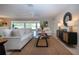 Cozy living room featuring tiled floors, an open floor plan, and access to outdoor views for relaxed living at 5621 Palm Aire Dr, Sarasota, FL 34243