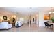 Bright and spacious living room with tile floors, white furniture and view of the kitchen at 5621 Palm Aire Dr, Sarasota, FL 34243