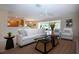 Spacious living room with tiled floors, a ceiling fan, and a seamless transition to the outdoor patio at 5621 Palm Aire Dr, Sarasota, FL 34243