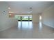 Spacious living room with neutral walls, tiled floor, and great natural light at 5621 Palm Aire Dr, Sarasota, FL 34243