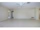 Bright living room featuring neutral walls, tiled floor, and ceiling fan at 5621 Palm Aire Dr, Sarasota, FL 34243