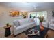 Bright living room with tiled flooring, seamless flow to the outdoors, and comfortable seating arrangement at 5621 Palm Aire Dr, Sarasota, FL 34243