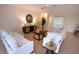 Airy living room featuring tiled flooring, comfortable seating, and ample natural light, creating a welcoming space at 5621 Palm Aire Dr, Sarasota, FL 34243