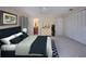 Well-appointed main bedroom with a comfortable bed, ample closet space, and a glimpse of the ensuite bathroom at 5621 Palm Aire Dr, Sarasota, FL 34243