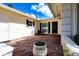 Quaint brick patio with a cozy seating area and potted plants at 5621 Palm Aire Dr, Sarasota, FL 34243