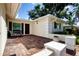 Relaxing outdoor patio area with brick flooring and charming decor at 5621 Palm Aire Dr, Sarasota, FL 34243
