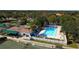 Aerial view of community pool with tennis courts and well-maintained landscaping at 5621 Palm Aire Dr, Sarasota, FL 34243