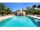 Inviting community pool with ample deck space for lounging and enjoying the outdoors with shade at 5621 Palm Aire Dr, Sarasota, FL 34243
